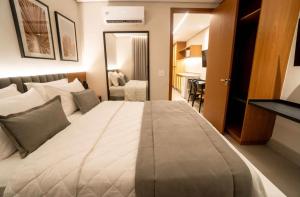 a bedroom with a large white bed in a room at Pyreneus Resort in Pirenópolis