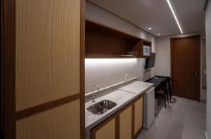 a kitchen with a sink and a counter top at Pyreneus Resort in Pirenópolis