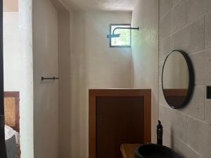 a bathroom with a sink and a mirror at Sak lool Tulum in Tulum