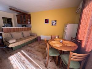 a living room with a table and a couch at Radetsky Apartment with FREE Private Parking in Haskovo