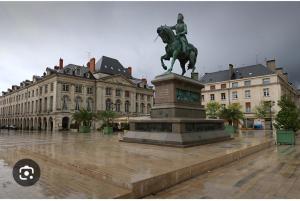 a statue of a man on a horse in front of a building at Joli studio plein centre proche Gare Orléans in Orléans