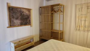 a bedroom with a bed and a book shelf at Casa Hurtere in Horta