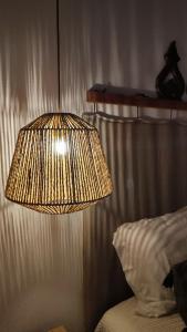 a lamp hanging over a bed in a bedroom at Casa Hurtere in Horta