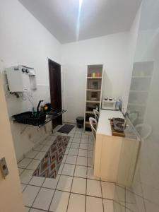a kitchen with a sink and a counter top at Manaira Suite 02 in João Pessoa +5 photos