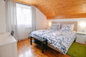 a bedroom with a bed with a wooden ceiling at Holiday house with a parking space Grabovac, Plitvice - 21998 in Rakovica