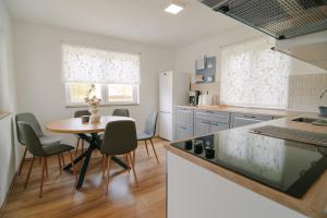 a kitchen with a table and chairs and a table at Holiday house with a parking space Grabovac, Plitvice - 21998 in Rakovica