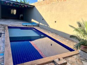 巴拉-杜加萨斯Espaço da Patroa的一座建筑物边的蓝色瓷砖游泳池