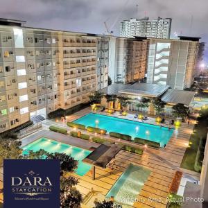 an aerial view of a building with a swimming pool at Affordable Condo Near Malls in Quezon City in Manila