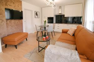 a living room with a couch and a table at Apartments and rooms with parking space Korenica, Plitvice - 24421 in Korenica