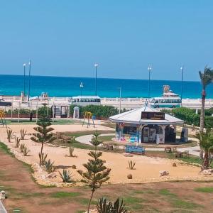 a park with a playground next to the ocean at Asmaa Rental Chalets Porto Matrouh for families in Marsa Matruh
