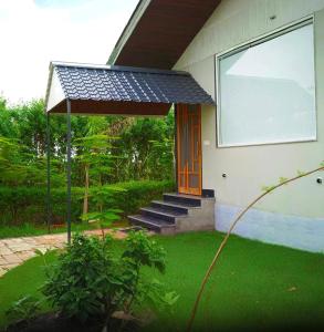 a house with a porch with a solar roof at Rocopie Farm in Rohtak