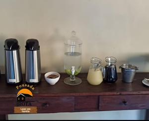 a counter with a blender and other ingredients on it at Pousada Rota in Paty do Alferes