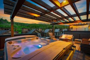 a hot tub on the balcony of a house at Mountain Wellness Retreat: Rejuvenate in Luxury in Winter Park