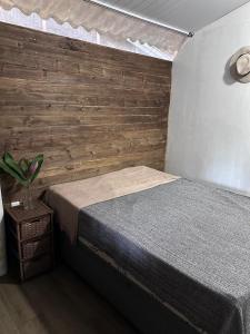 a bedroom with a bed and a wooden wall at Rancho Pé na Areia- Ubatumirim Giba Panamá in Ubatuba +37 photos