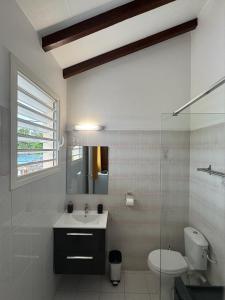 a bathroom with a sink and a toilet and a window at Résidence O Gosier in Le Gosier +29 photos