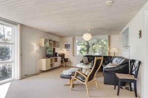 a living room with a couch and a table at Well-Located Holiday Home In Ristinge, Langeland in Humble