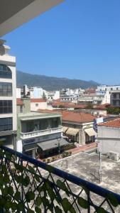 a view of a city from a balcony at Central D1 City Apartment in Volos +25 photos