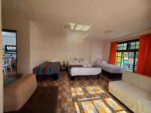 a living room with two beds and a couch at Casa Rentera D Elías 5 in Puerto Baquerizo Moreno