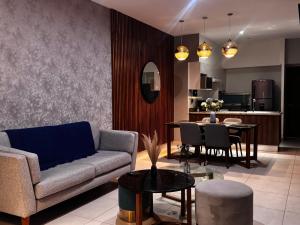 a living room with a couch and a table at Vía Montejo, Mérida Yucatán in Mérida