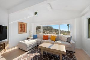 a living room with a couch and a table at Pacific Coast Suites - Oceanfront Living in Los Angeles