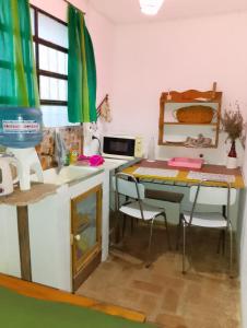 a kitchen with a desk and a table with chairs at Departamento MGS in Valle Hermoso