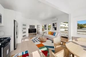 a living room with a couch and a table at Pacific Coast Suites - Oceanfront Living in Los Angeles