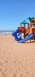a group of playground equipment on the beach at Apartamento Temporada Jacaraípe - ES in Serra
