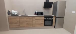 a kitchen with a sink and a stove and a refrigerator at Basset 2 in Valencia
