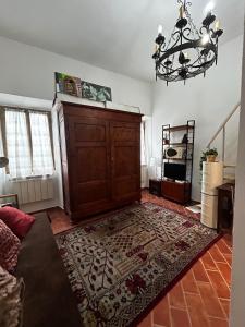 a living room with a large wooden cabinet at La Casa di Noa in Florence