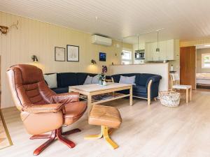a living room with a couch and a chair at Holiday home for family in Denmark in Løgsted +15 photos