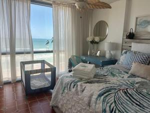 a bedroom with a bed and a view of the ocean at Daytona oceanfront two-bedroom suite in Daytona Beach