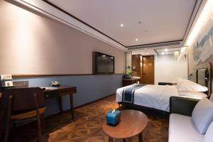 a hotel room with a bed and a desk at Nost algia S Hotel Hangzhou West Lake & Lingyin Temple 时光漫步S酒店杭州西湖店 Free laundry service, Free fresh ground coffee in Hangzhou +117 photos
