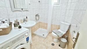 a small bathroom with a toilet and a sink at Polyxeni's apartment in Kastoria +12 photos