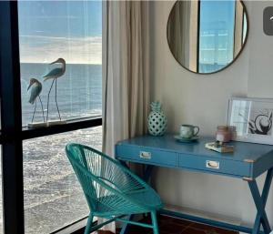 a desk and a chair in a room with a window at Daytona oceanfront two-bedroom suite in Daytona Beach +12 photos
