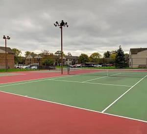 a tennis court with two tennis courts at Sweet home in Indianapolis
