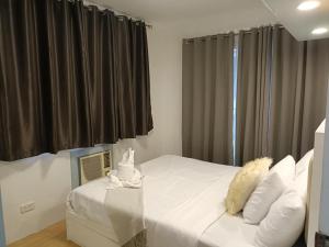 a bedroom with a bed with two stuffed animals on it at One Oasis 2br Condo in Davao City