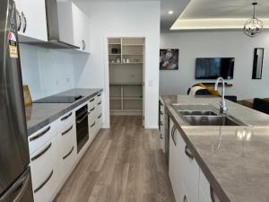 a kitchen with a sink and a counter top at Jack Adamson Retreat in Twizel +8 photos