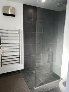 a bathroom with a shower and a toilet at Jack Adamson Retreat in Twizel