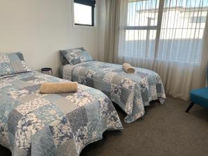 a bedroom with two beds and a window at Jack Adamson Retreat in Twizel
