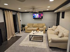 a living room with two couches and a tv at Solo travelers and couple in Sterling