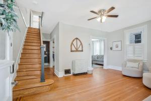 a living room with a staircase and a ceiling fan at Historic 3 BR Home - 15 Min Walk to N-MC Stadium in Annapolis