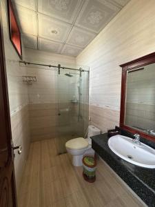a bathroom with a shower and a toilet and a sink at LENA HOTEL in Danang +30 photos