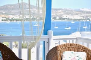 a balcony with a view of the water and boats at Victoria Apartement-Loft with amazing sea view in Adamas Port in Adamas +11 photos