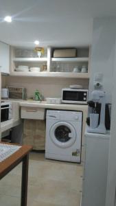 a kitchen with a washing machine in a kitchen at Victoria Apartement-Loft with amazing sea view in Adamas Port in Adamas