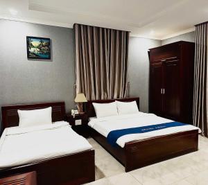 a hotel room with two beds in a room at LENA HOTEL in Danang