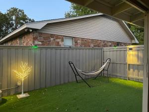 a chair sitting in a yard next to a fence at Hugo Cozy Cottage in Hugo