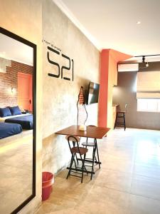a dining room with a table and a bedroom at the AMARTYA in Yogyakarta