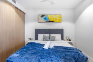a bedroom with a bed with a stuffed animal on it at Your QW Escape - Pool Gym & Stunning Sky Deck View in Brisbane
