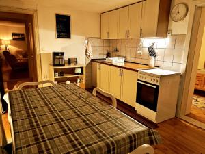 a kitchen with a table with a plaid table cloth at Apartman Charna in Livno