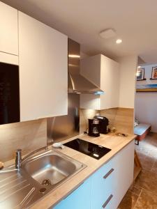 a kitchen with a sink and a microwave at Logis Nature & Mer in Saint-Josse